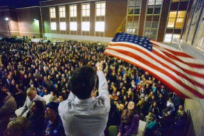 DENVER, CO - FEBRUARY 1: Peter Wright holds an American flag above hundreds of people who were forced to organize in a parking lot during the caucus at East High school in Denver, Colorado on March 1, 2016. 18 precincts were represented at East High School and thousands of people turned out for the caucus. Organizers had anticipated about 20% of people from their precincts would turn out and many more actually came. (Photo by Helen H. Richardson/The Denver Post)
